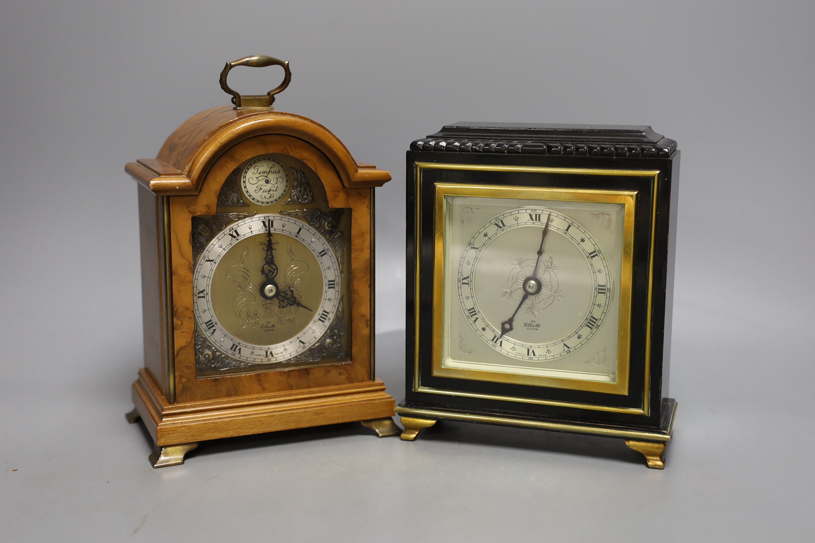 Two Elliott mantel clocks, one walnut and one lacquered.